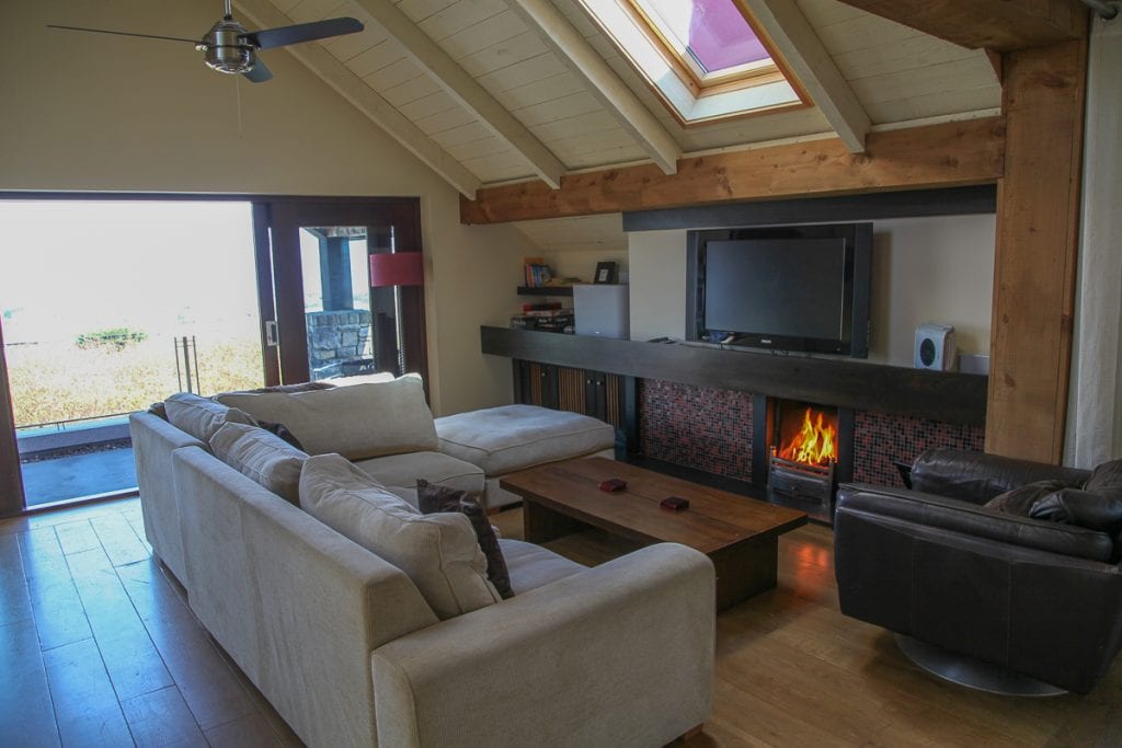 The open-plan living room with the fire lit