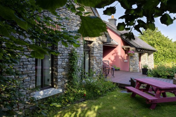 The lodge and picnic bench seen through the trees
