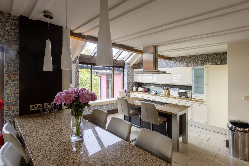 Kitchen with a granite island and breakfast stools