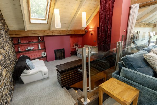 Snug with a red wall, a roof window and a sofa