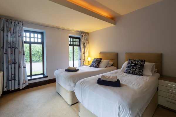 Twin bedroom with two single beds and patio doors