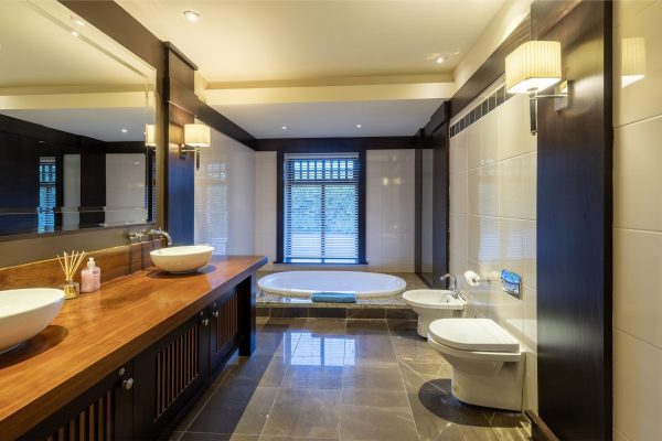 Family bathroom with twin basins on a wooden vanity and a bath