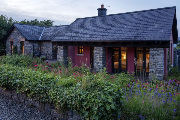 The lodge at dusk seen across the garden